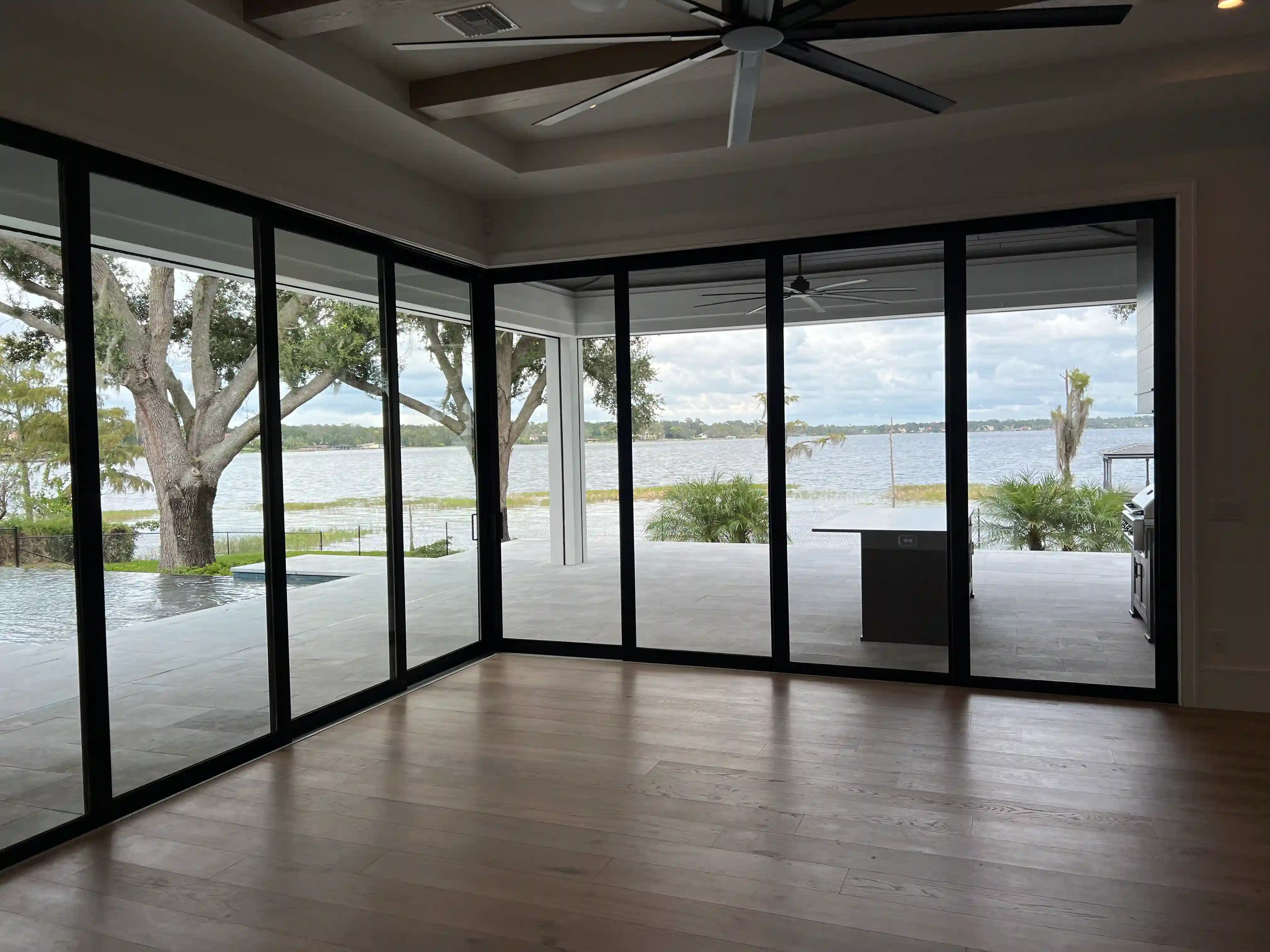 A screened lanai with a lake view, finished by the PG Quality Solutions team
