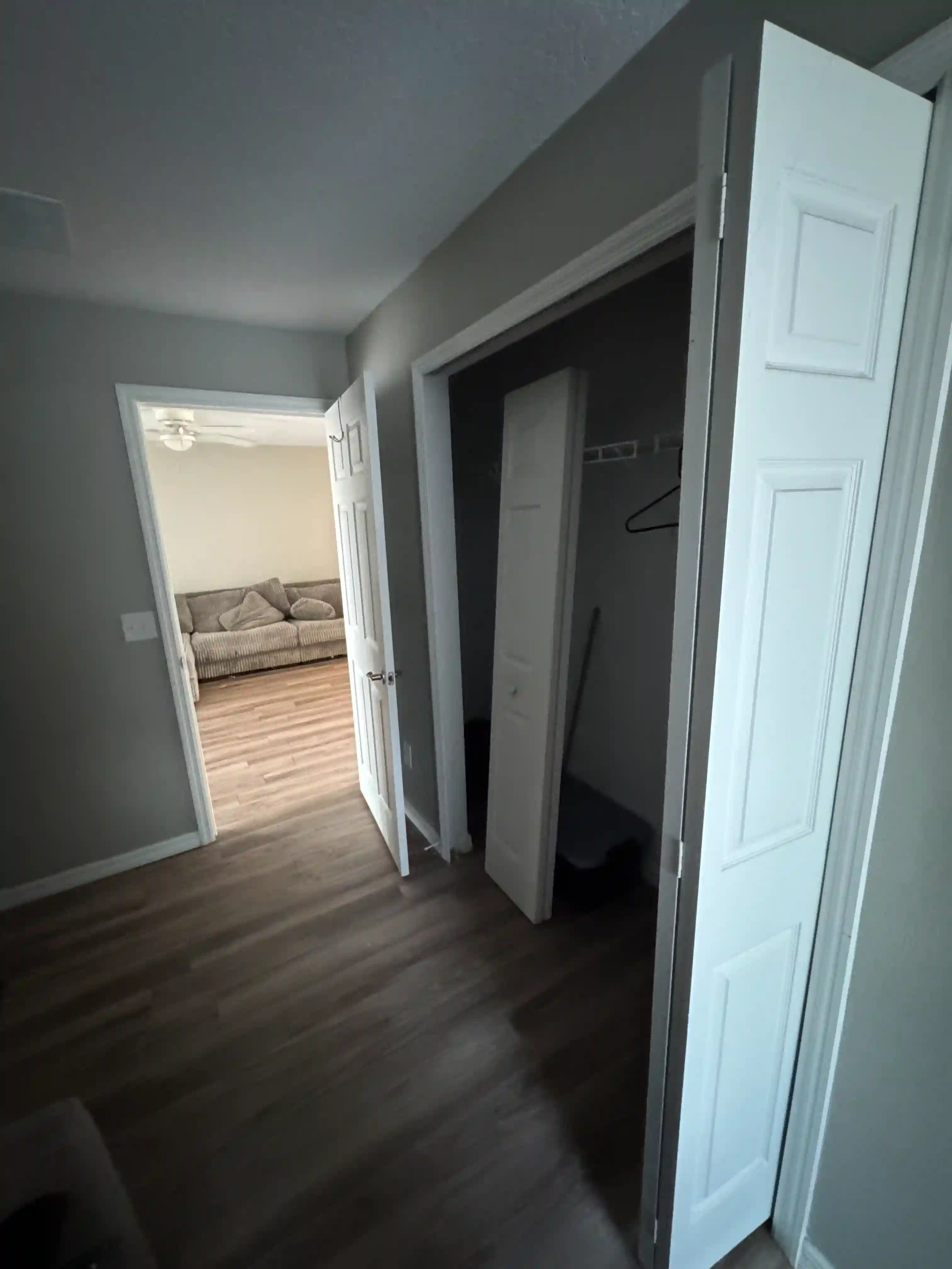 Hallway closet open view kitchen vacant unit