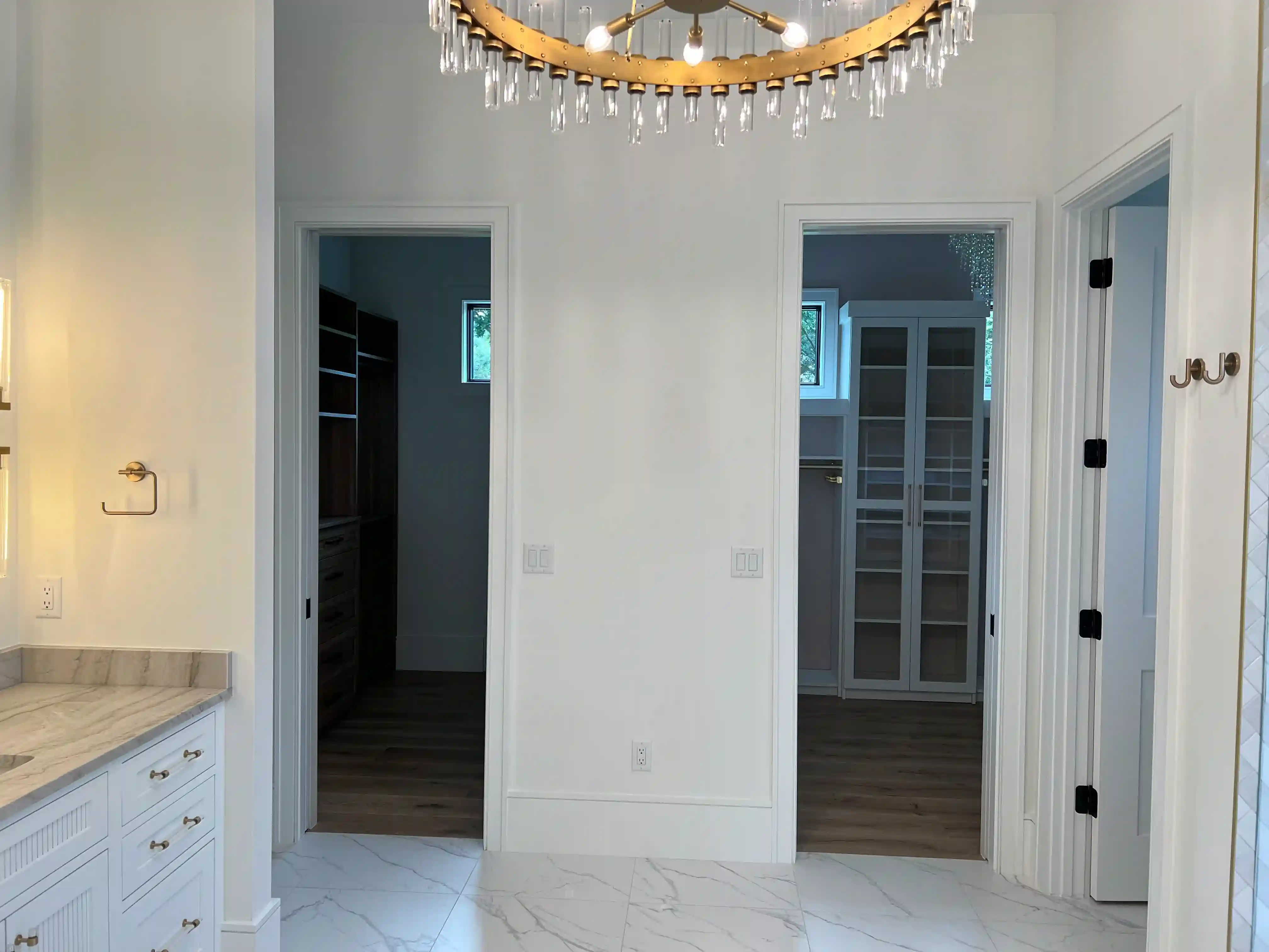 A hallway leading to walk-in closets, finished by the PG Quality Solutions team