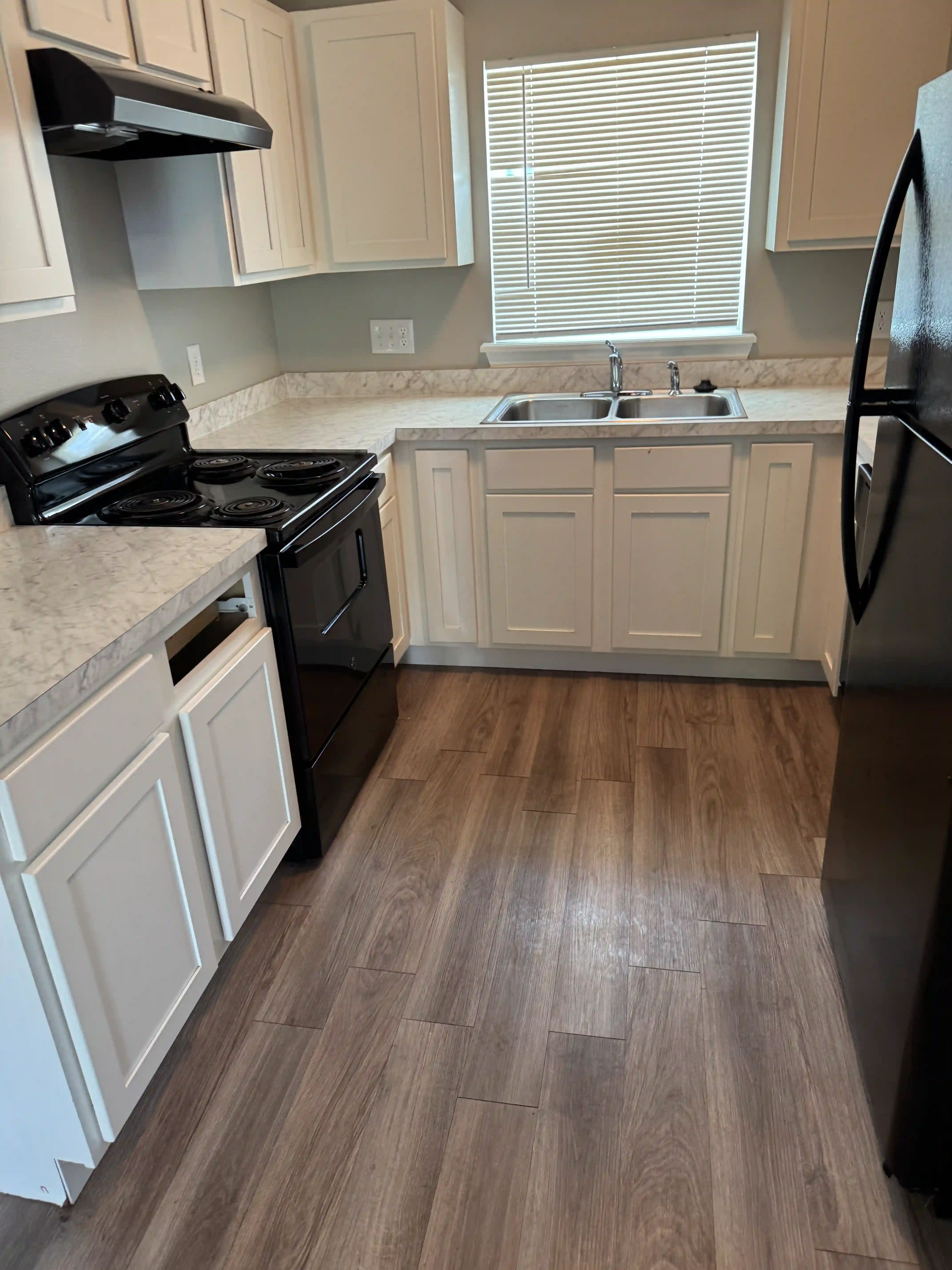 Kitchen cleaned white cabinets black appliances