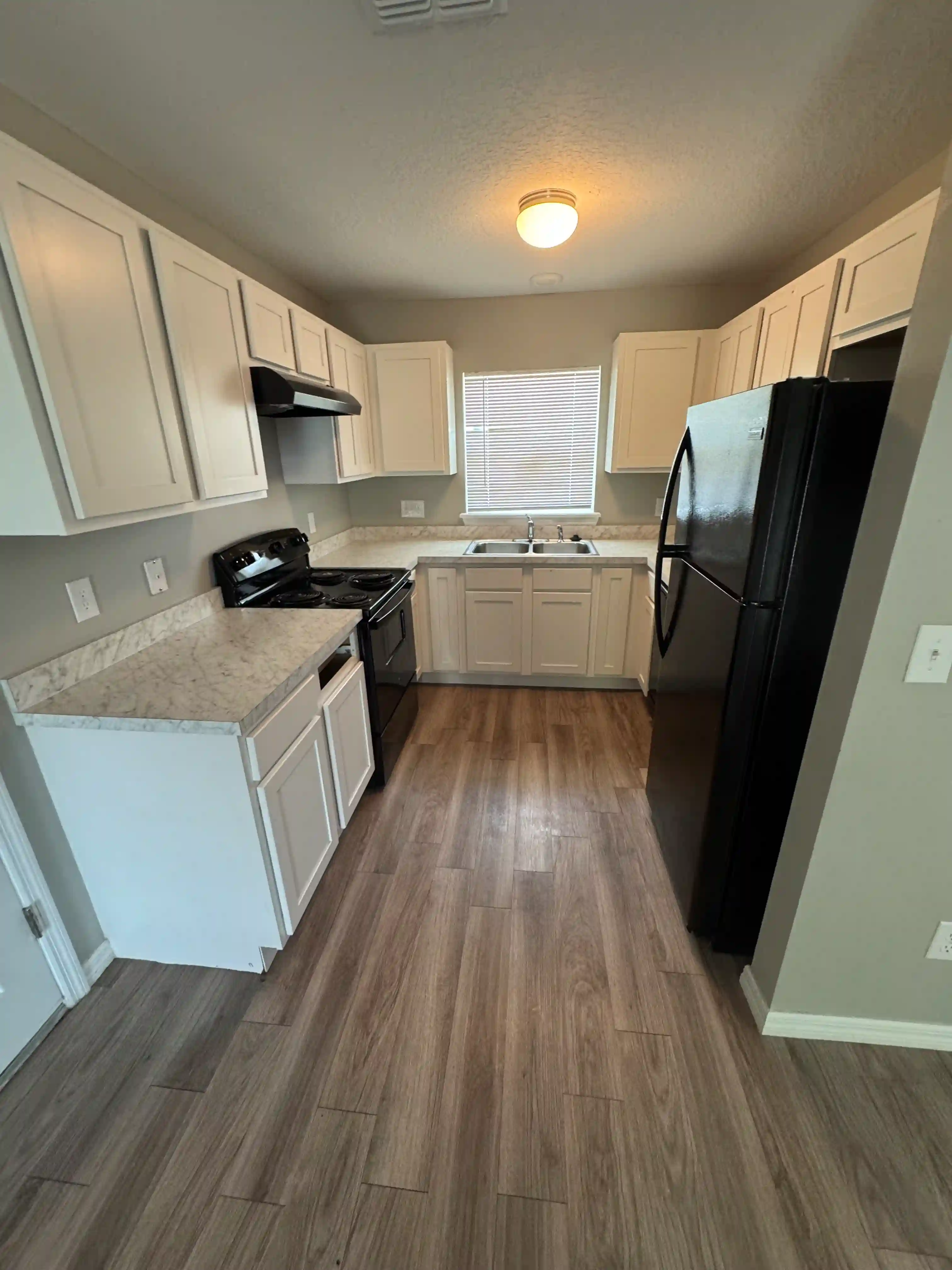 Kitchen cleaned white cabinets black appliances