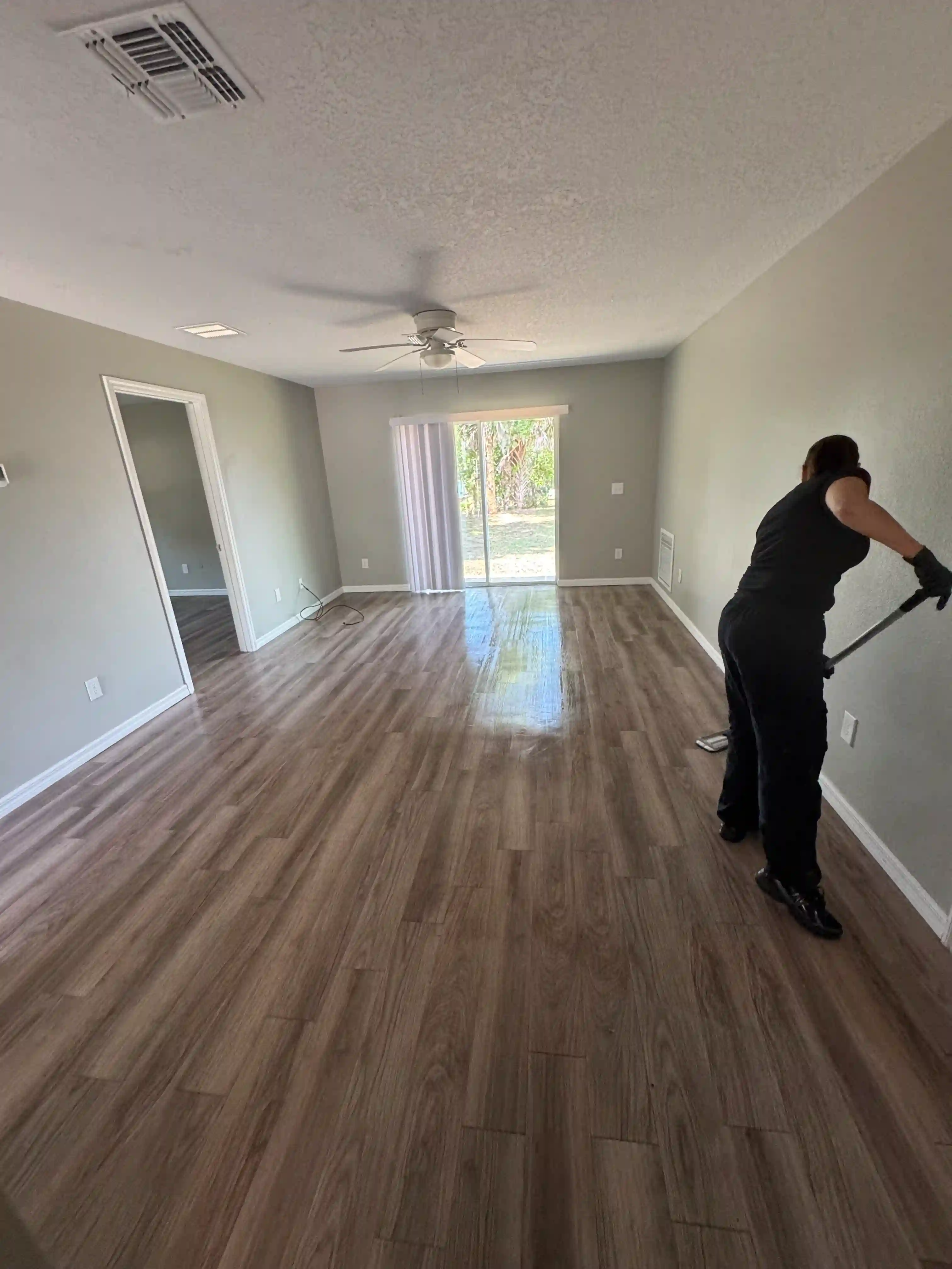 Living room floor cleaning worker mopping