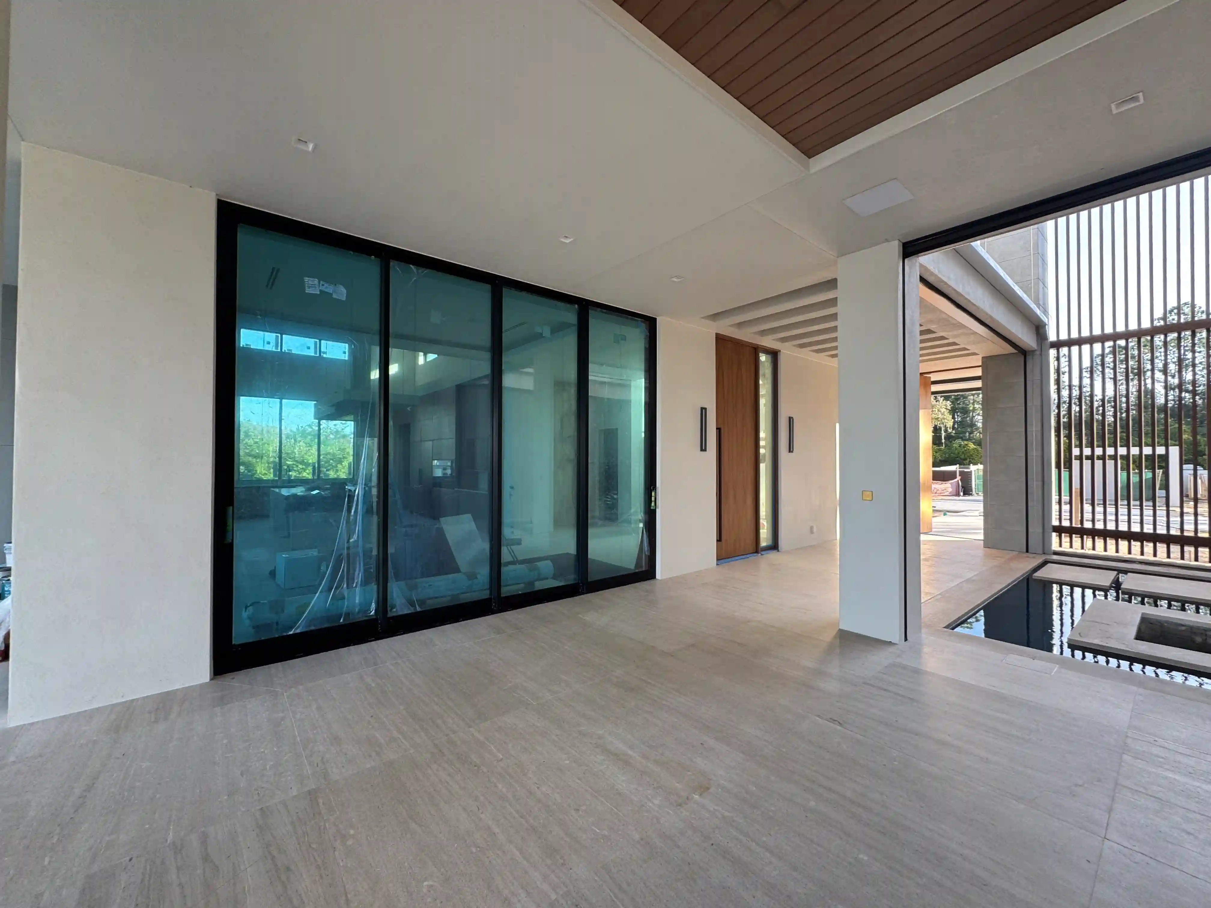 Modern home glass entry pool view