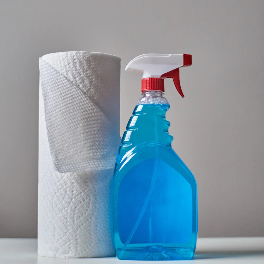 A glass cleaner spray bottle and paper towel roll
